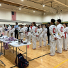 Several taekwondo athletes wait for their results at an ACATA tournament at UNC Charlotte.